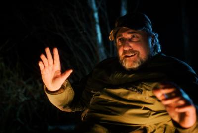 A man in the woods talks