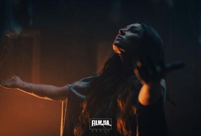 A woman with her arms extended looking up 