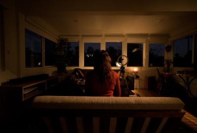 A woman sits on a sofa