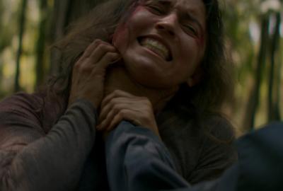 Young Woman Struggling While Being Held Up By Neck