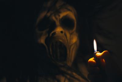 The Lady Beneath holds a lighter