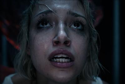 A woman looks up in fear