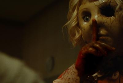 Dolly holds a finger to the mouth shh....