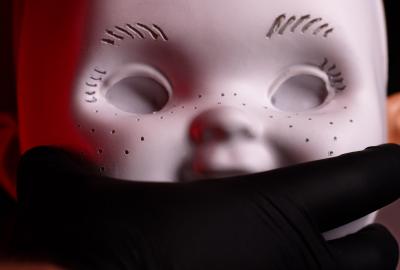 A chucky doll head is prepped for airbrushing