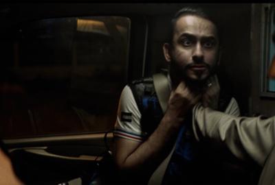 Man holds another man by the neck