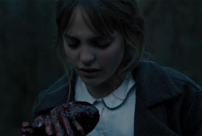 A young girl holds a heart