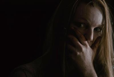 Woman covers her mouth