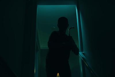 Soul Casket Still: Figure grasping crowbar