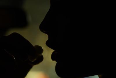 Someone about to swallow drugs