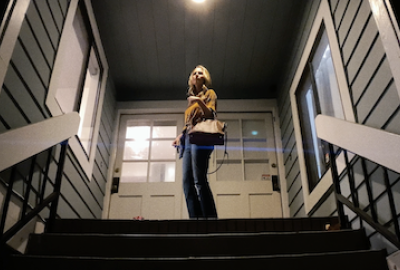 A woman looks down a staircase