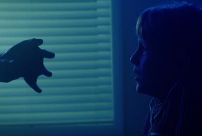 Webbed hand reaches out to a boy