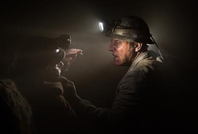 A miner holds another miner 