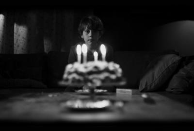 Boy staring at a cake