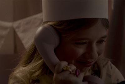 Abracitos film still young girl listening to a phone call