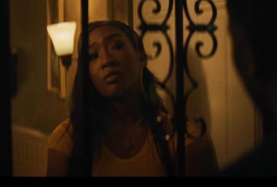 Pruitt & Igoe film still of woman looking out the door