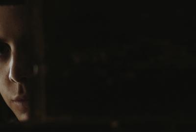 Woman looks out of a door