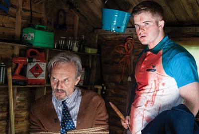 Let the Wrong One In film still one man tied up and another with a knife