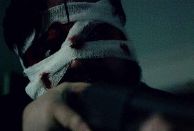 A man with bandages and blood on his head