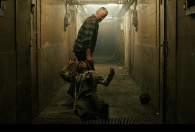 Woman is dragged by a man down a hallway