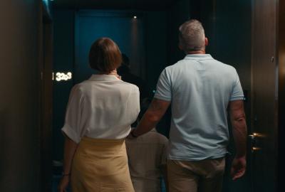 A family walks towards their hotel room