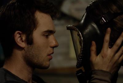 ZONE 2 young man looks at masked person